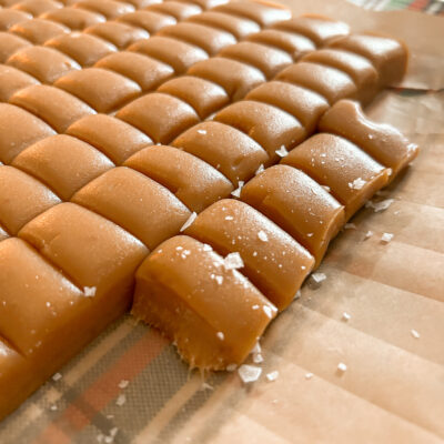 close up of homemade caramels sprinkled with flakey sea salt