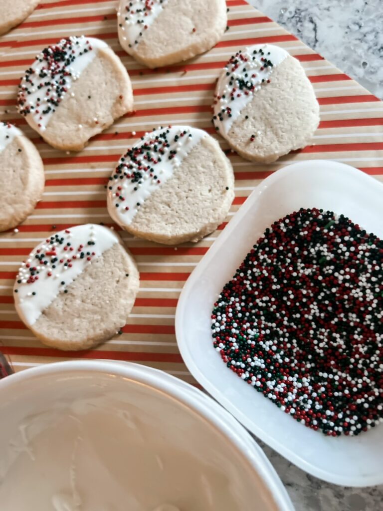chocolate dipped shortbread cookies with melted chocolate for dipping and fun festive sprinkles
