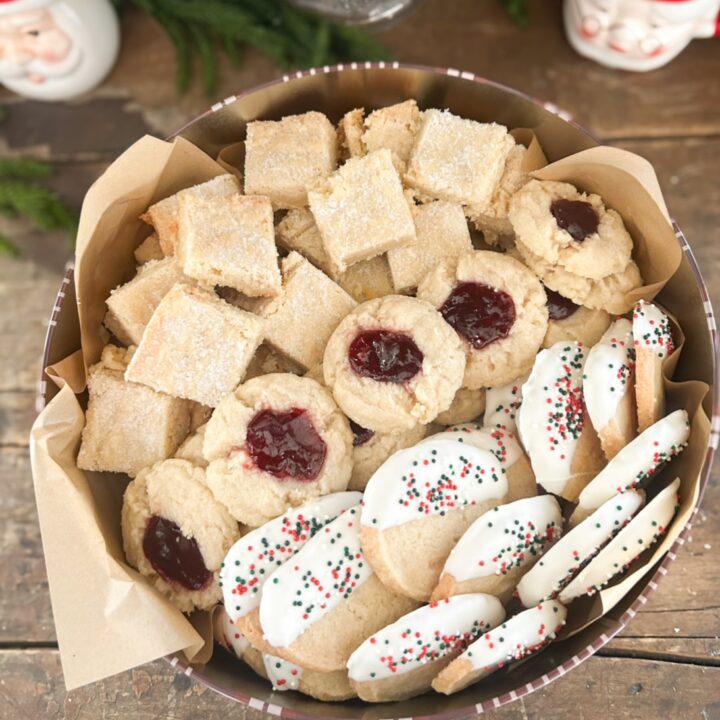 tin of shortbread made three ways. raspberry thumbprint, chocolate dipped shortbread cookies and traditional shortbread.