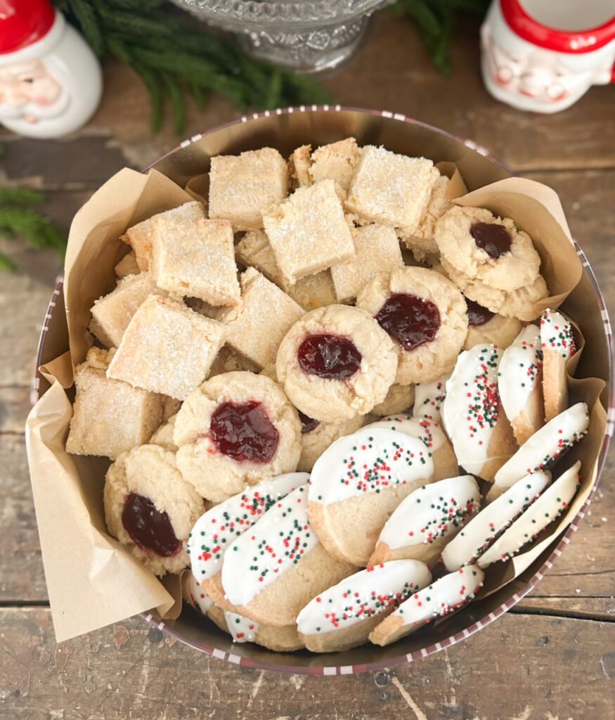 tin of shortbread made three ways. raspberry thumbprint, chocolate dipped shortbread cookies and traditional shortbread.